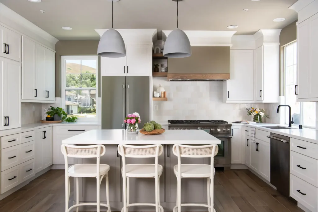 Base of the U serves as a storage zone (fridge + pantry) with countertop prep space adjacent